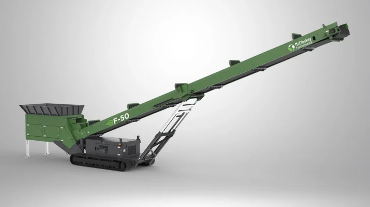 Angled view of the Feeder Stacker with compact tracked chassis, 10′ hopper, and long discharge conveyor.
