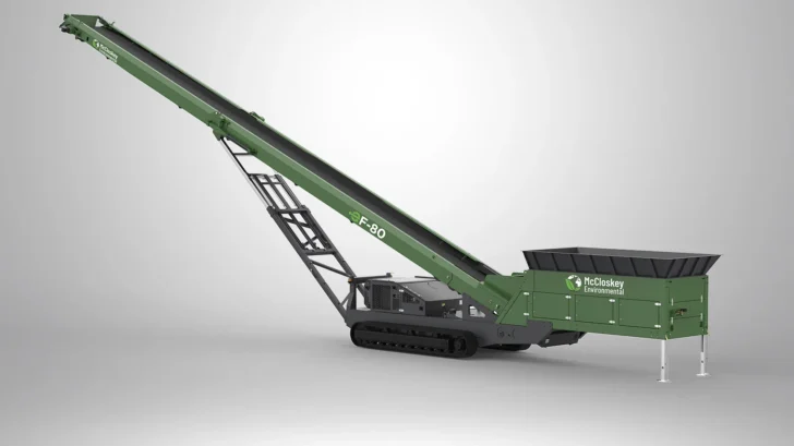 McCloskey tracked stacker with large loading hopper and long stockpiling conveyor extended.
