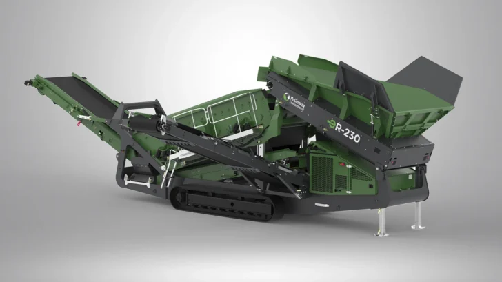 Rear angle of the McCloskey Environmental ER-230 showing the feed hopper, hydraulic folding conveyors, service access, and crawler tracks.