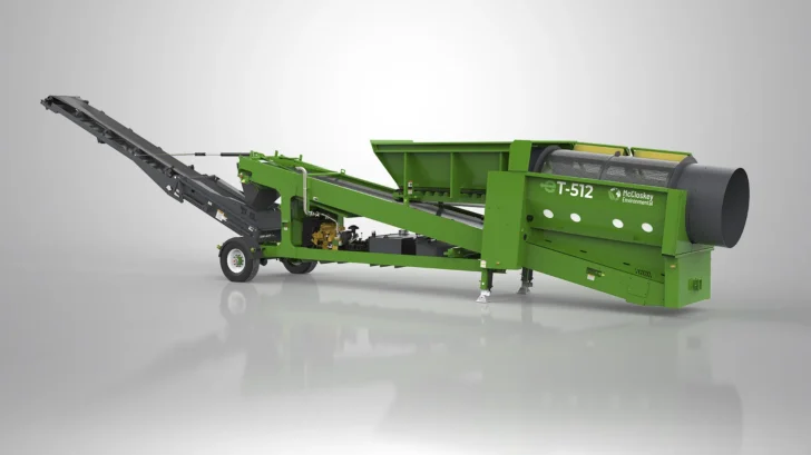 Rear angle of the McCloskey Environmental ET-512R Trommel with radial conveyor and wheeled mobile chassis.
