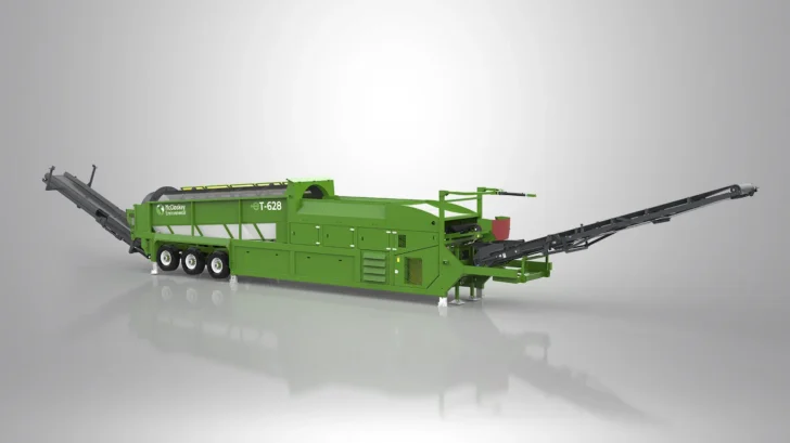 Side view of the Trommel showing its long screening drum and hydraulic folding conveyors.